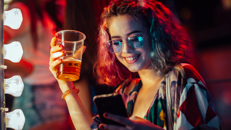 Person using phone while drinking