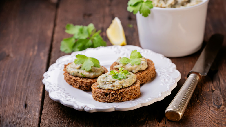 Three pieces of toast with codfish mousse on a plate