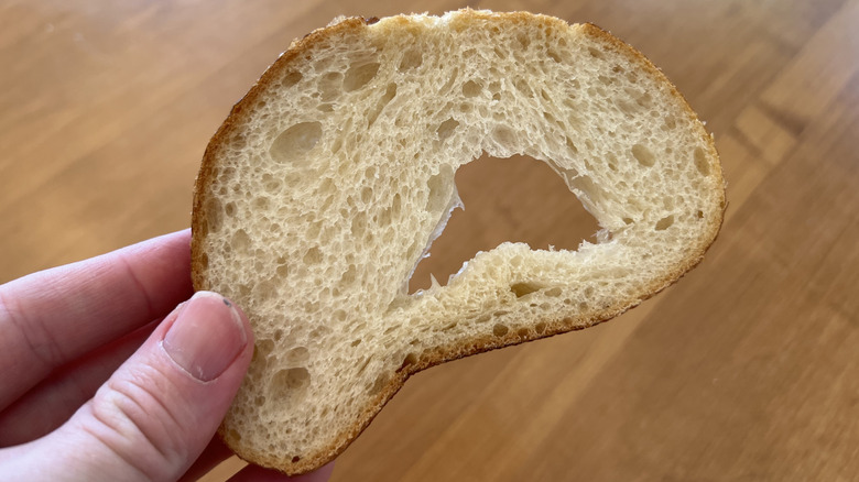 Person holding a slice of bread