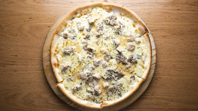 Chicken on a pizza with sauce