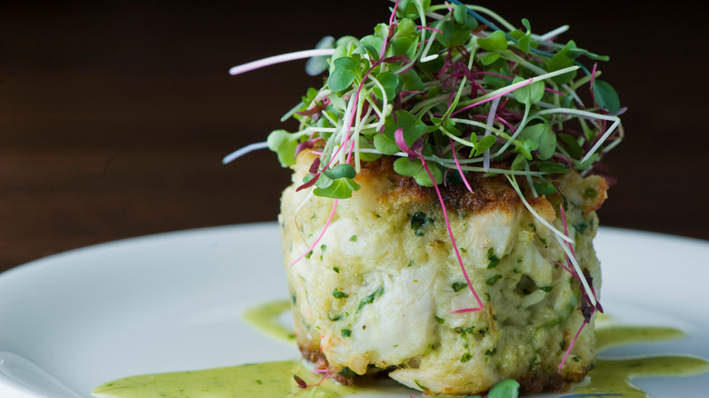 A plate of crab cakes garnished with fish roe