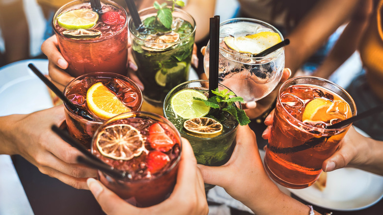 A collection of people holding cocktails