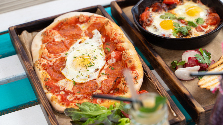 Shakshuka pizza on a wooden tray