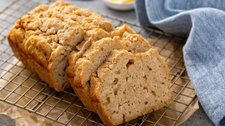 Batch of beer bread sliced and cooling on a rack