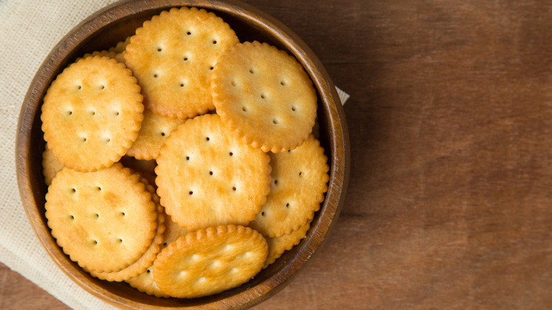 Wooden bowl full of Ritz Crackers on table