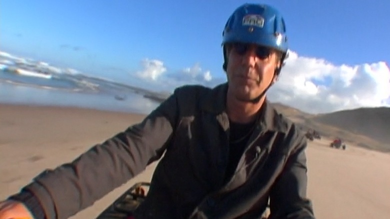 Anthony wearing a helmet on an ATV.