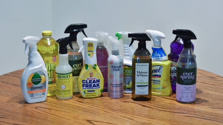 A collection of all-purpose cleaners on a wooden table