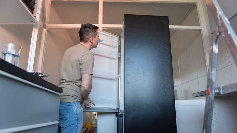 Technician inspecting a refrigerator