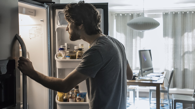Person looking inside refrigerator