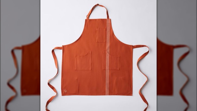 An orange apron on a white background