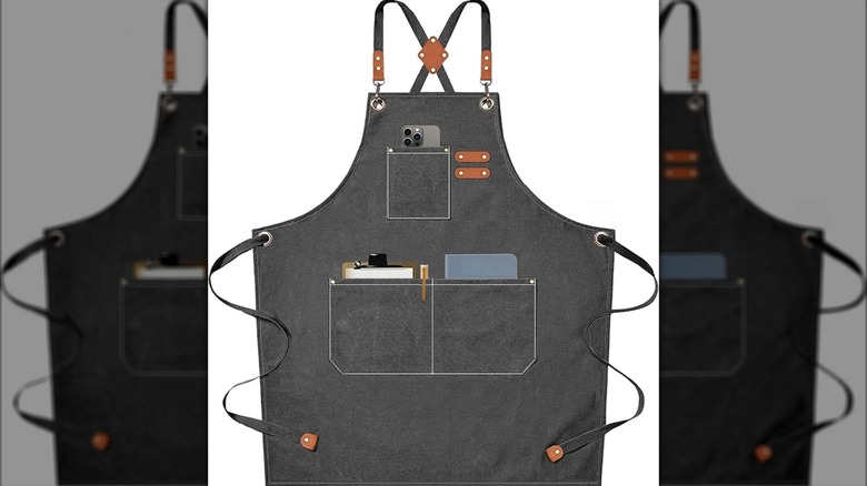 A grey apron with pockets on a white background