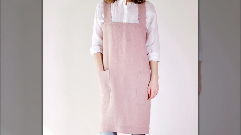 A woman wearing a pink linen apron