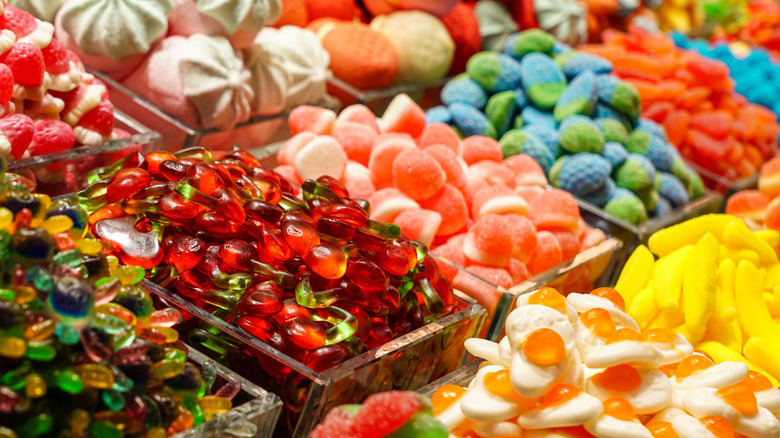 Candy sits in dispensers at a candy store