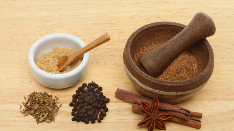 Chinese five spice components in a dish on a wooden table
