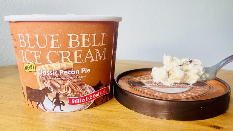 Spoonful and carton of Blue Bell Classic Pecan Pie Ice Cream