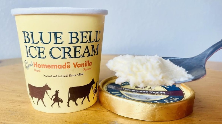 Spoonful of Blue Bell Homemade Vanilla Ice Cream with opened pint