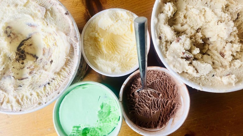 Overhead view of opened cartons of ice cream in different flavors