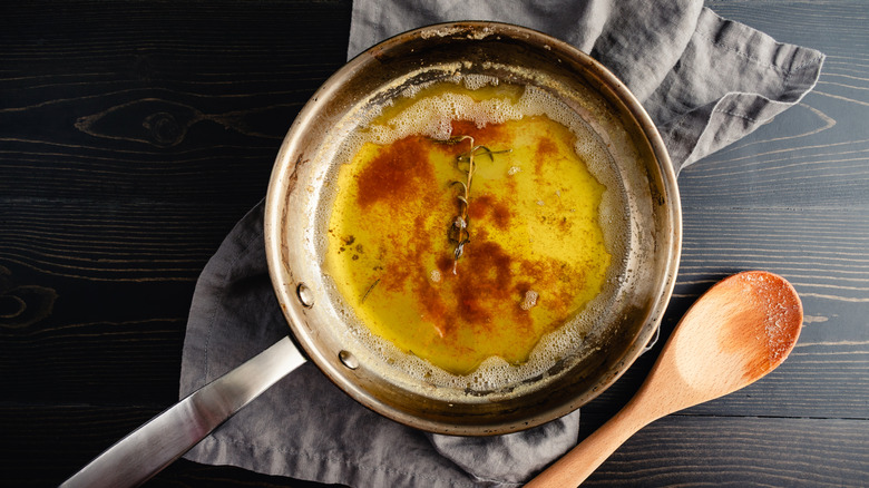 A pan of browned butter with rosemary