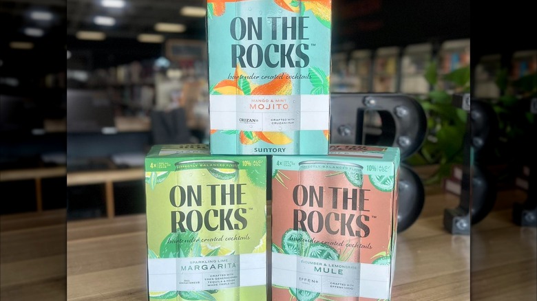 Boxes of On the Rocks canned cocktails are stacked on top of one another