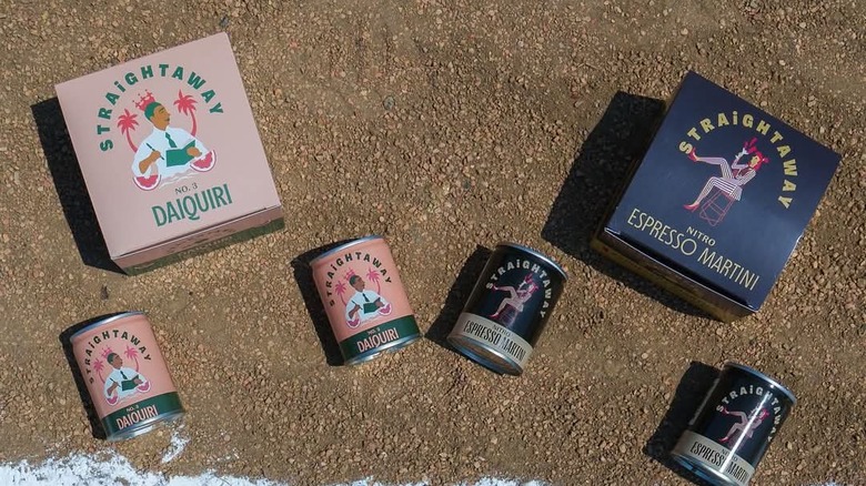 Cans of Straightaway canned cocktails are spread out on the pavement