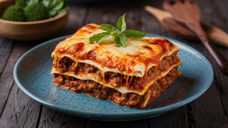 A serving of lasagna on a blue plate