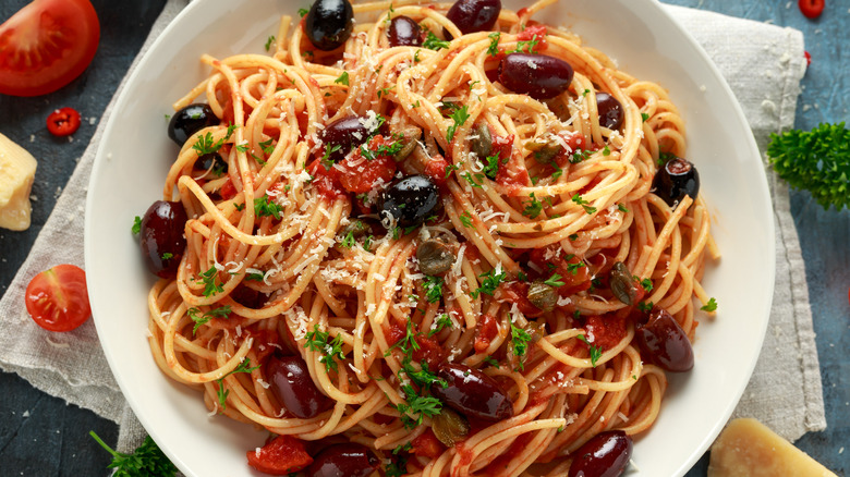 Pasta with puttanesca sauce including garlic, anchovies, capers, and olives