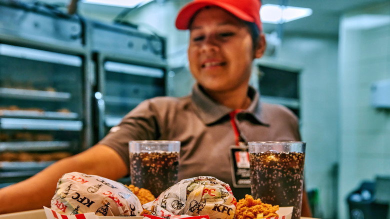KFC staff member smiling while serving food