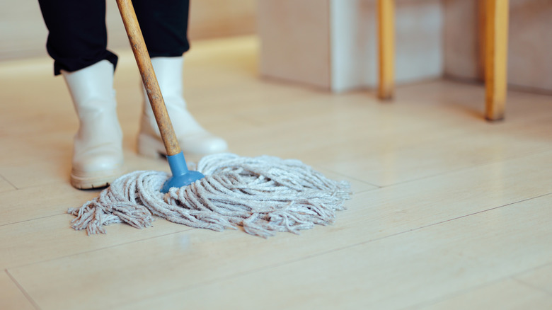 Person cleaning restaurant floor with a mop
