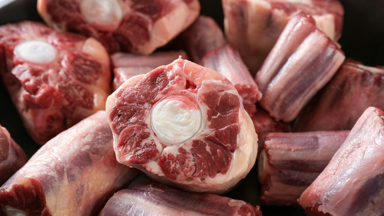 Person holding package of oxtails