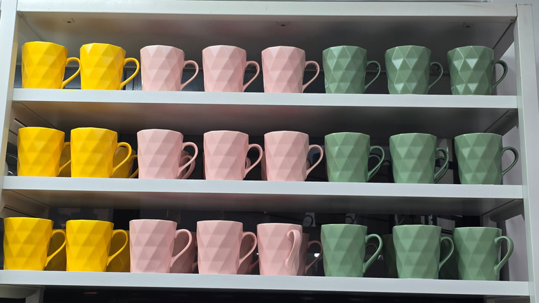 Colorful mugs on open shelving