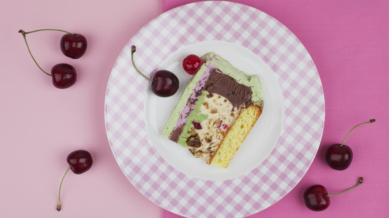 slice of ice cream pie on plate with cherries