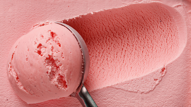 scooping strawberry ice cream with scooper