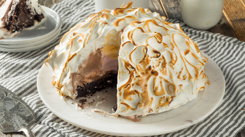 A Baked Alaska with a slice missing