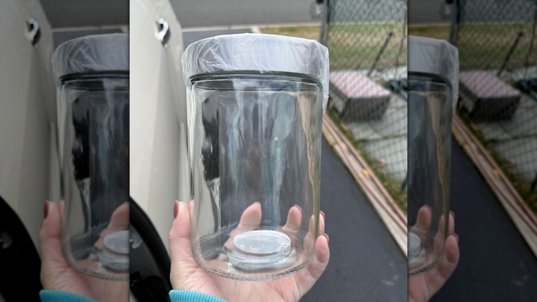 Hand holding a glass jar