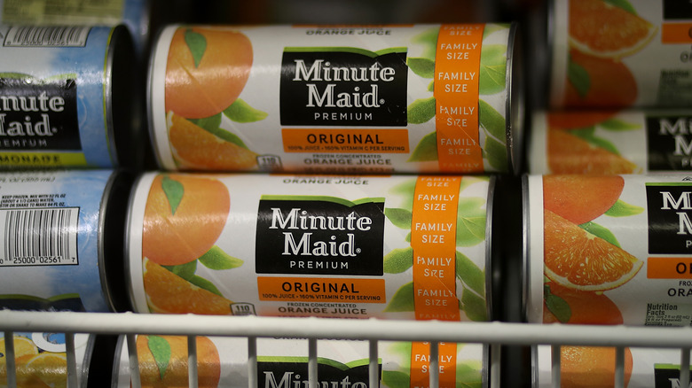 Cans of Minute Maid frozen concentrated orange juice in a freezer case