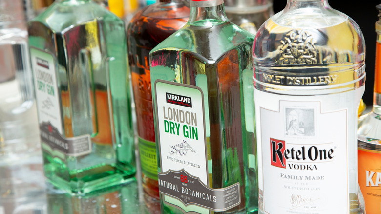 A bottle of Kirkland London dry gin next to a bottle of Ketel One vodka