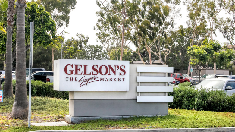 The Gelson's store sign with trees and cars in the background