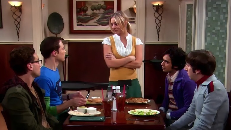 Big Bang Theory characters sitting at the Cheesecake Factory