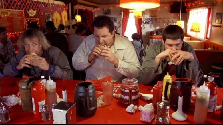 Dumb and Dumber characters eating spicy burgers at a table
