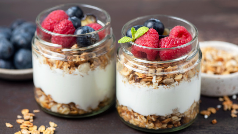 2 small parfaits with berries in jars