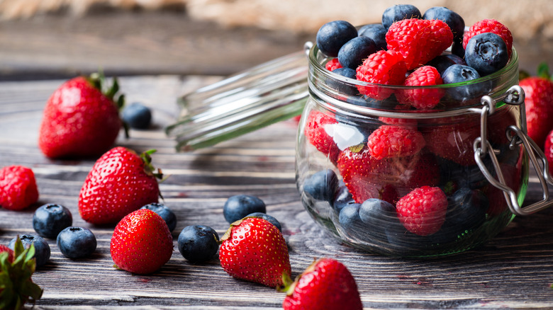 strawberries and blueberries in a small jar