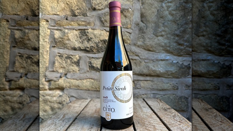 A bottle of L.A. Cetto Petite Syrah on a table
