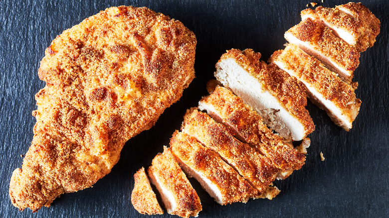 Breaded chicken breast on board