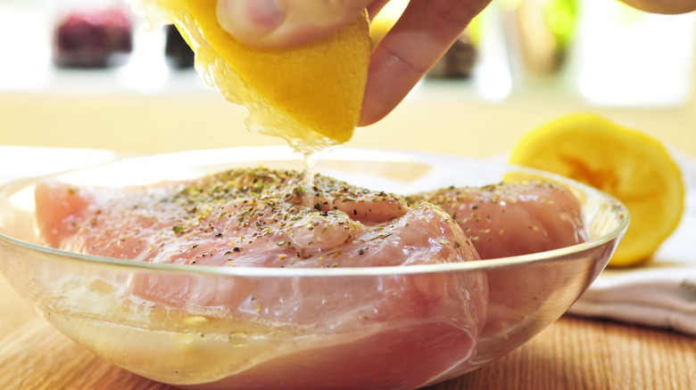 Chicken marinating in lemon juice