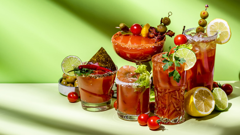 Several different bloody marys come with various garnishes.