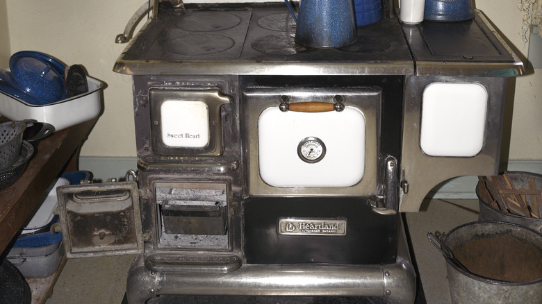 Antique stove and oven with tin kettles