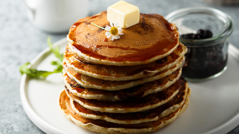 Stack of pancakes topped with knob of butter