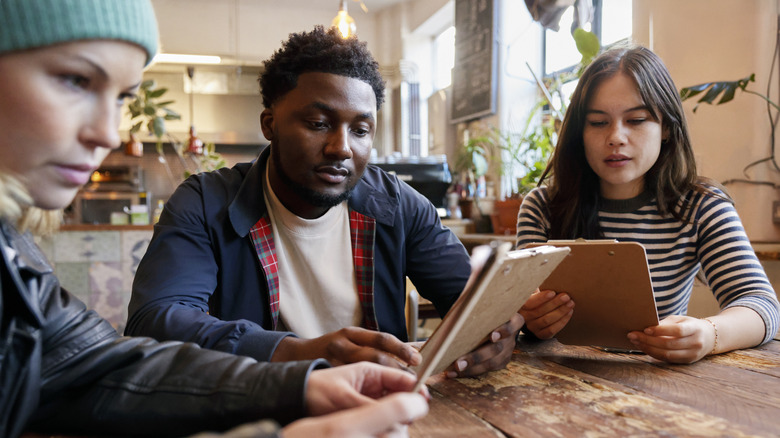 Group of friends looking at menus