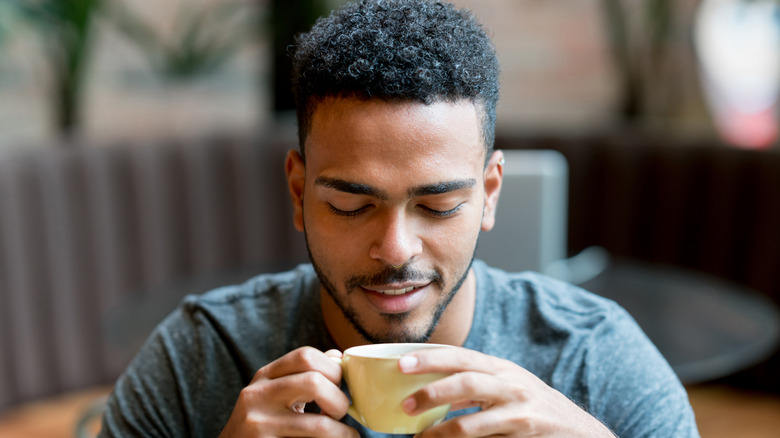 Man sipping on a coffee