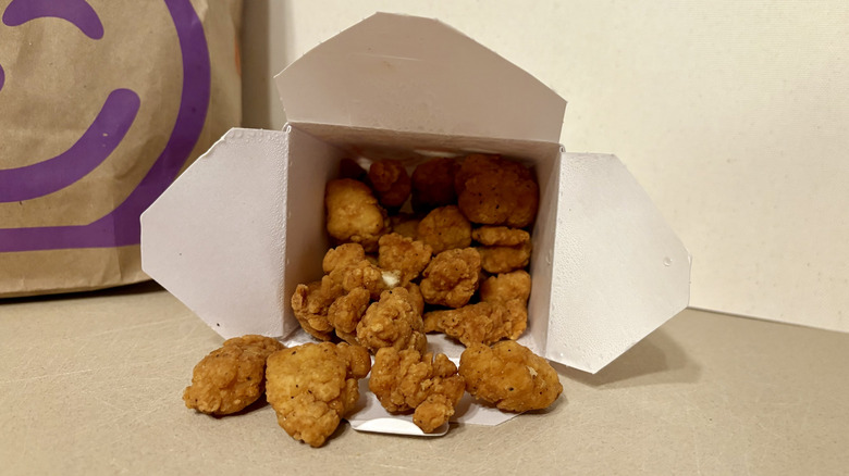 Popcorn chicken pouring out of their box